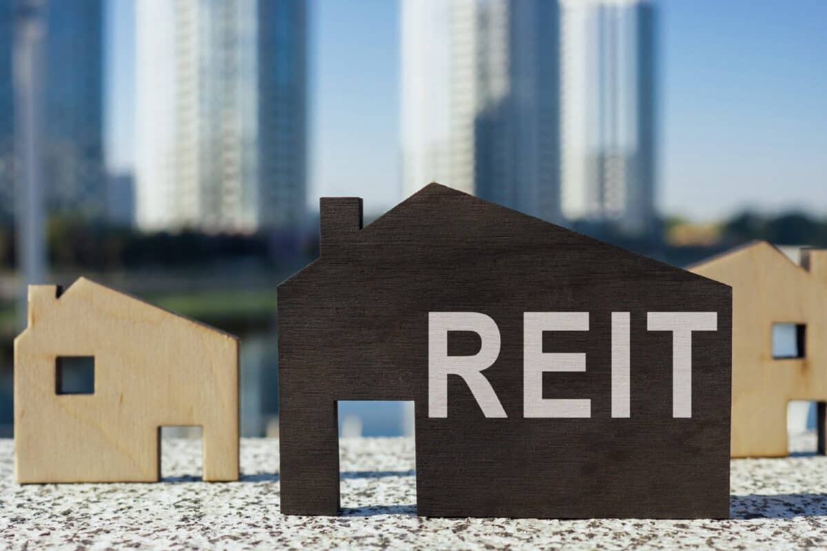 House models and one with REIT - standing for real estate investment trust - written on it.